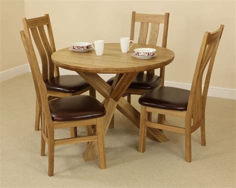 The Solid Oak Round Table With Crossed Legs And Four Arched Back Chairs
