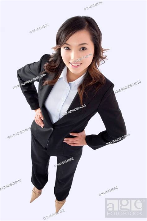 Young Business Woman Standing With Arms Akimbo And Smiling At The