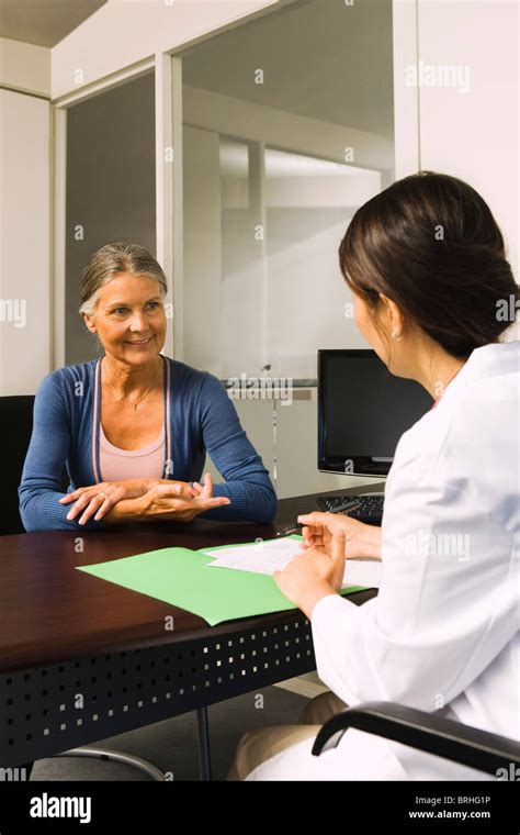 Woman Talking To Doctor Stock Photo Alamy