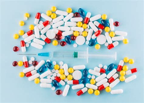 free photo colorful pills and syringe