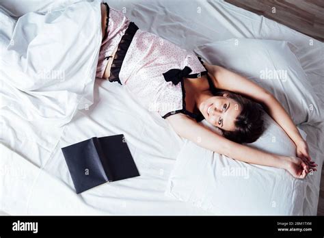 Girl In Pajamas Lying On The Bed With A Book Before Bed Stock Photo Alamy