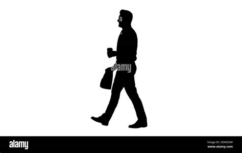 Silhouette Businessman Walking With Take Away Coffee And Paper Bag With