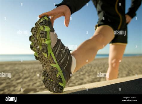 Female Runner Stretching On Beach Stock Photo Alamy