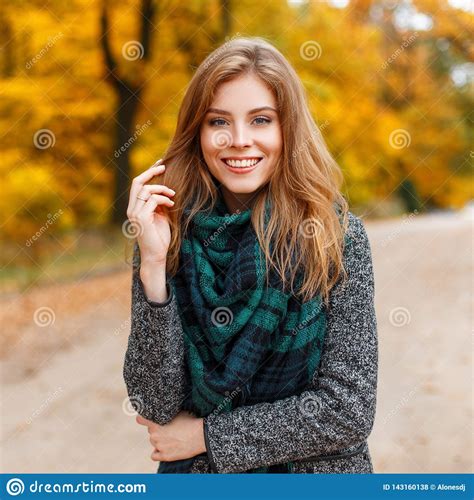 Positive Attractive Young Woman In A Warm Gray Fashionable ...
