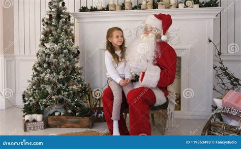 Cute Little Girl Singing A Christmas Song Sitting On Santa Claus Lap