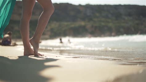Female Bare Feet Walking On The Wet Sand On The Beach Female Legs