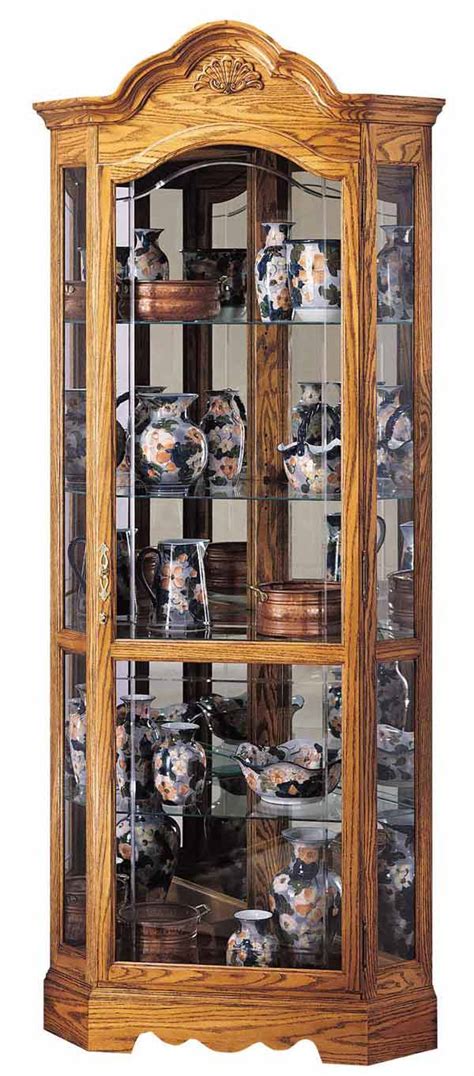 Mirrors made of glass, wood, metal and glass, curio cabinets can be designed to fit any. Howard Miller 680-207 Wilshire Oak Corner Curio Cabinet