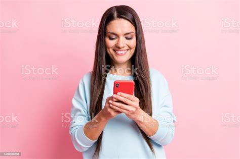 Photo Of Adorable Sweet Mature Woman Wear Blue Pullover Typing Modern Gadget Isolated Pink Color