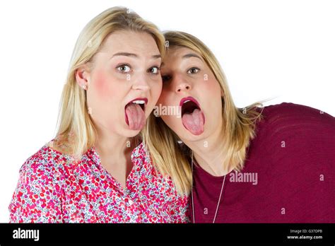 Two Girls Sticking Tongue Out Stock Photo Alamy Play Two Babe Girls Tongue Stock Min