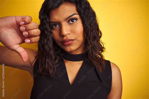 Transsexual Transgender Woman Wearing Black T Shirt Over Isolated Yellow Background With Angry