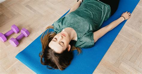 Slim Woman Lying In Shavasana Pose On Yoga Mat · Free Stock Photo