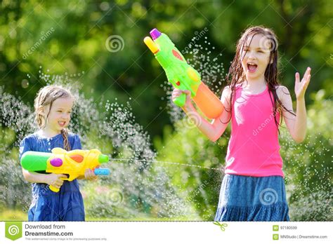 Adorable Little Girls Playing With Water Guns On Hot Summer Day Cute