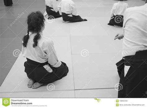 We train to avoid and deflect being hit, grabbed or pushed. Aikido Training Participants Sit On A Mat Stock Photo ...