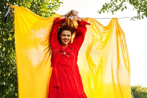 Beautiful Woman Posing In Red Dress Outdoors Yellow Cloth Stock Image