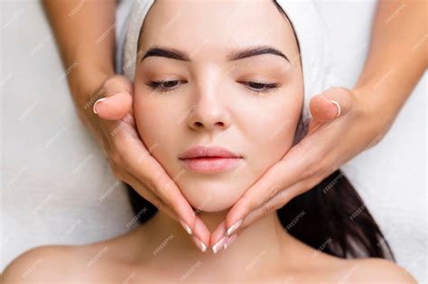 Premium Photo Professional Antiaging Facial Massage Action Relaxing Facial Treatment At Spa