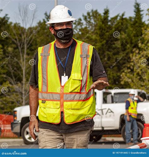 A Construction Worker Wearing Full Ppe As Well As A Facemask Editorial