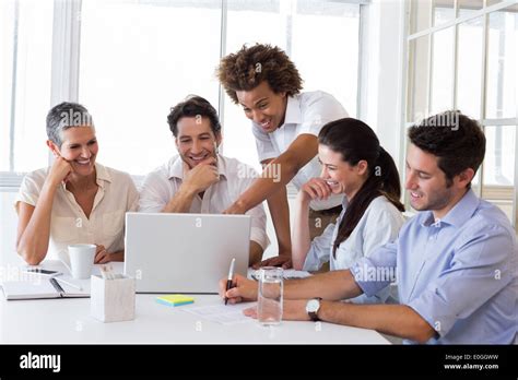 Laughing Business People Working Together Stock Photo Alamy