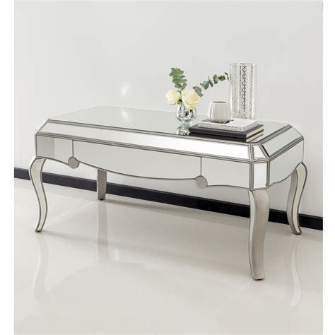 This contemporary coffee table features a mirrored top that will lighten up your living room and provides a great surface to put items on display. Glass Mirrored Coffee Table