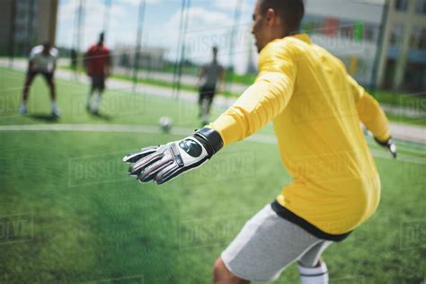 Side View Of African American Goalkeeper Standing On Soccer Pitch