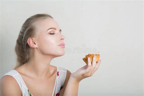 Playful Blonde Woman Having Fun With A Sweet Dessert With Nuts Stock