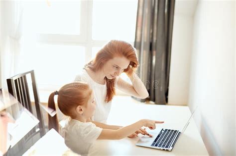 Red Haired Mom And Her Cute Daughter Watching Cartoons On Laptop Stock Image Image Of Laughing