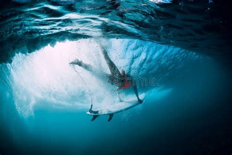 Surfer Woman With Surfboard Dive Underwater With Under Big Ocean Wave