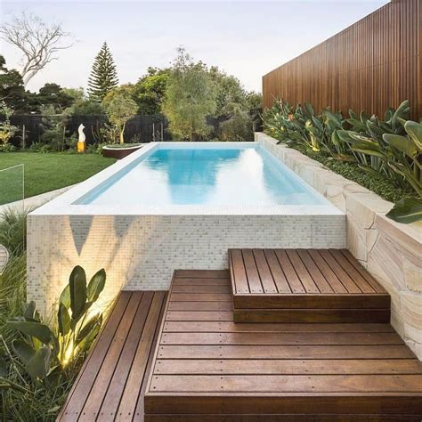 A Wooden Deck Next To A Swimming Pool