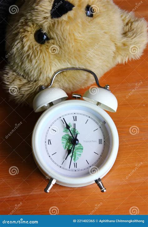 Top View White Alarm Clock With Teddy Bear On Wood Floor Stock Image