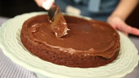 Spreading A Chocolate Frosting Filling On The First Layer Of A Homemade Cake Free Stock Video