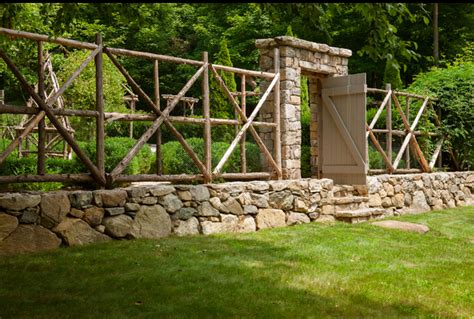 Dogs can't dig under it, the wood doesn't rot, and you end up with a great setting bench. Fence and rock wall. | Garden gates, Garden structures ...
