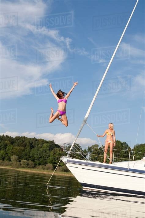 Girl Jumping From Boat Into Water Stock Photo Dissolve