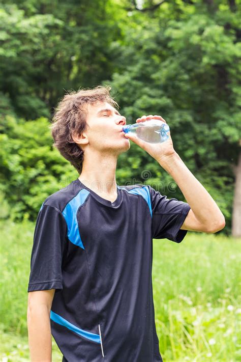 Sport Man Drinking Water From A Bottle Cold Drink After Outdoor