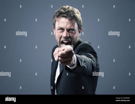 An Angry Businessman Points At The Camera Stock Photo Alamy