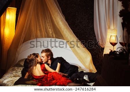 beautiful couple  kissing   bedroom stock photo