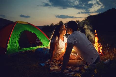Romantic Camping A Young Couple Sitting By The Bonfire Stock Image