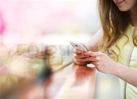 smiling girl with smartphone in stock image colourbox