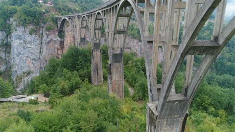 Drone Flight Past Pillars Of Durdevica Tara Bridge Infrastructure