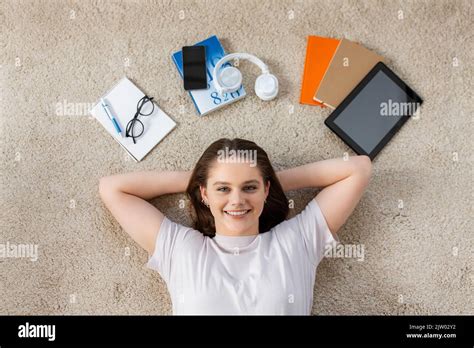 Happy Student Girl With Books And Gadgets On Floor Stock Photo Alamy