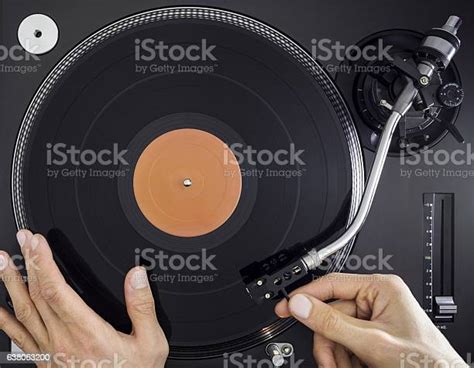 Dj Turntable Hands Placing Tonearm On Vinyl Record Top View Stock Photo