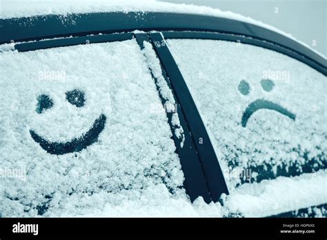 Happy And Sad Smiley Emoticon Face In Snow On Car Windows Winter