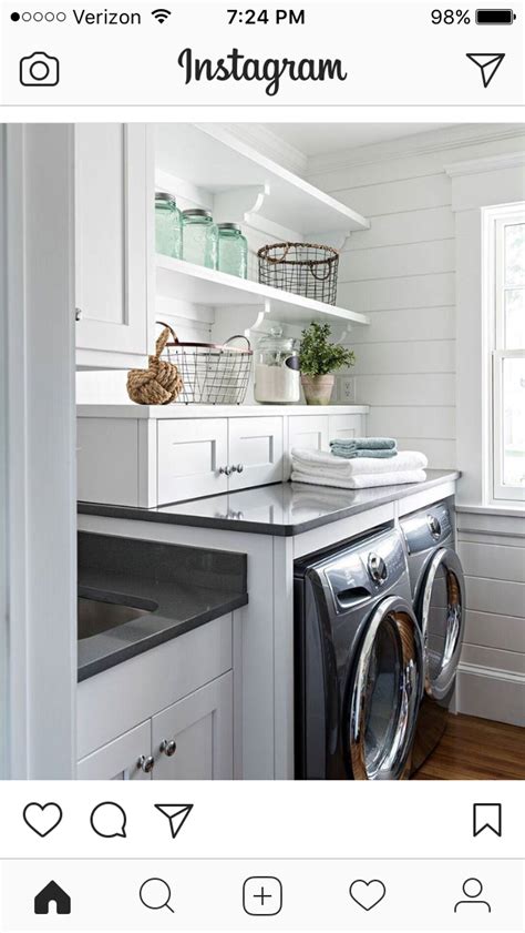 Washer and dryer area with cabinets to hold supplies. Farmhouse laundry room image by Stylecraft Custom Wood ...
