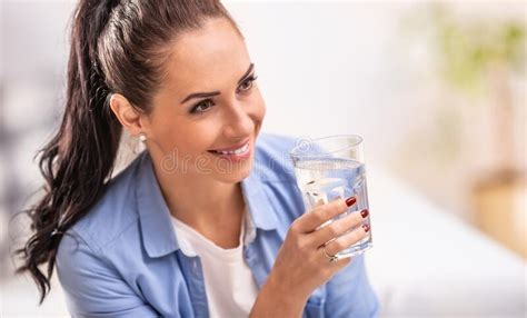 Smiling Girl Holds A Glass Of Pure Water In Her Hand Stock Photo