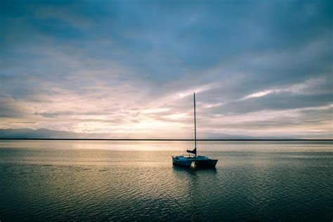 Boat Floating In Calm Sea In Evening Time · Free Stock Photo