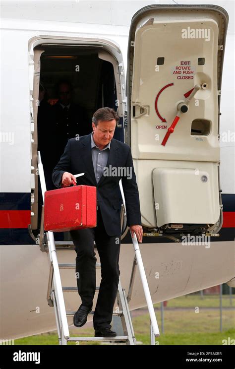 Britains Prime Minister David Cameron Steps Off Of His Plane As He