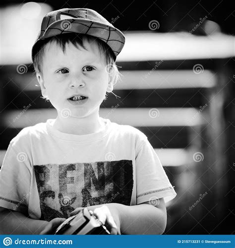 Black And White Photo Of A Little Boy Wearing A Cap Stock Image Image