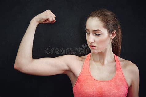 Keep Calm And Build Muscles A Young Woman Flexing Her Muscles Stock