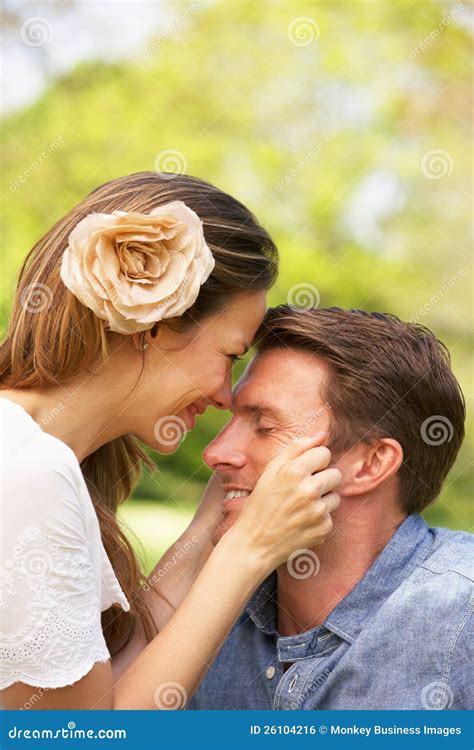 Romantic Couple Sitting In Field Of Summer Flowers Stock Photo Image