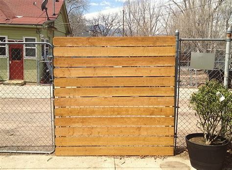 You can build an outdoor gate using fences. Genius! The Easy Way to Add Privacy to a Chain-Link Fence ...