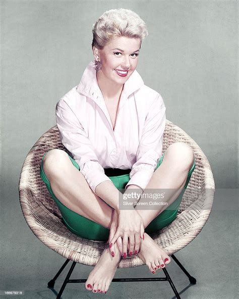 American Actress And Singer Doris Day Sits Cross Legged And Barefoot