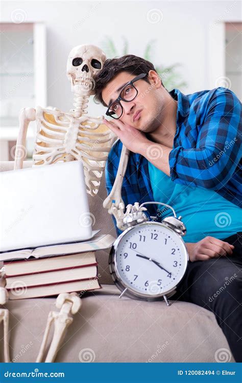 The Student Studying With Skeleton Preparing For Exams Stock Photo